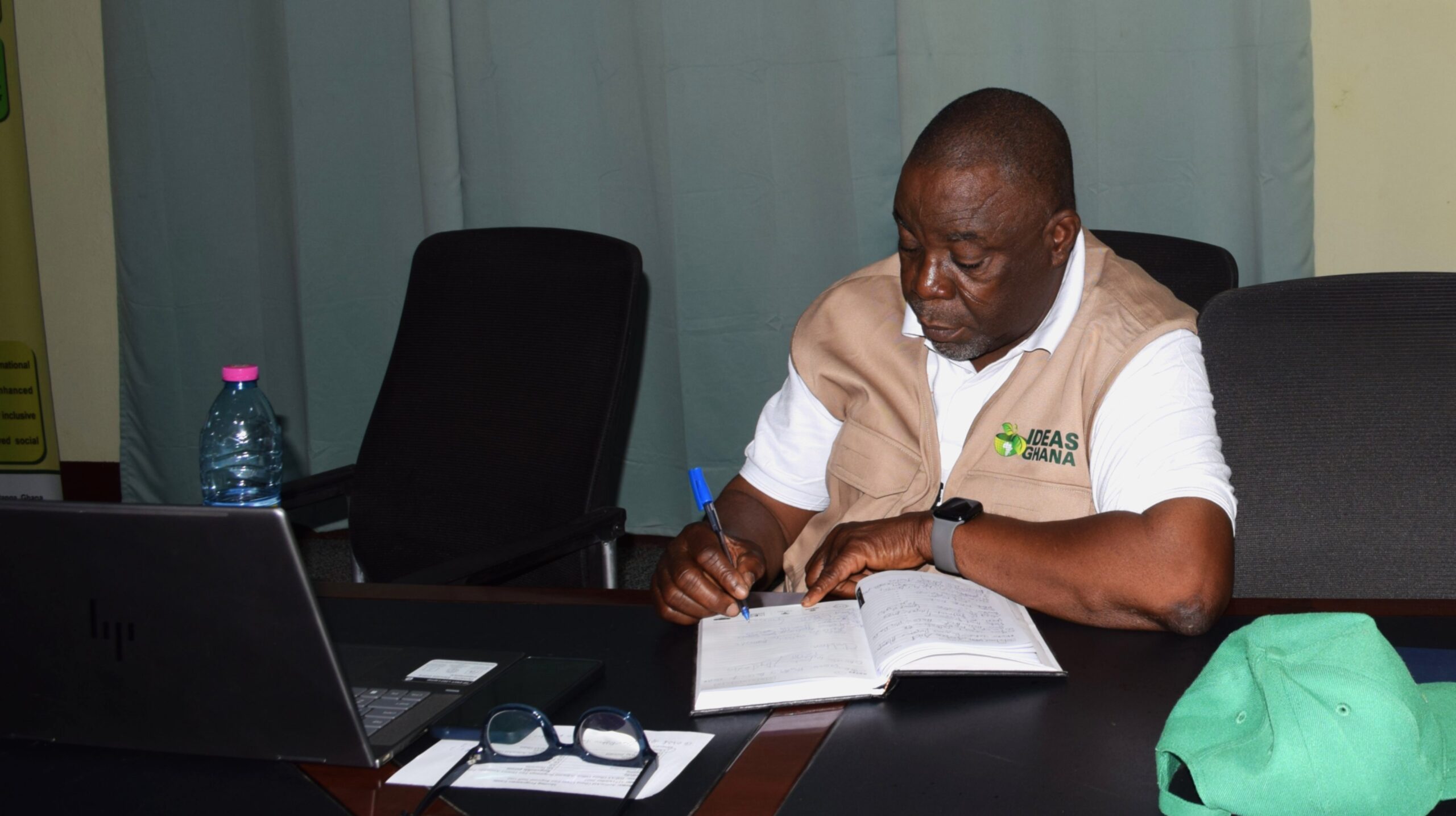 Dr Joseph Ayembilla working at the central desk in the office